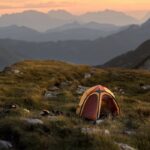 Enchanting sunset view with a tent in Austria's mountains, ideal for outdoor adventure.